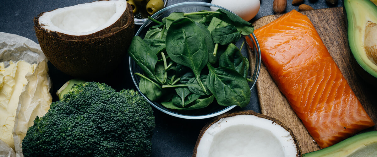 Paleo Diet Foods: broccoli, coconut, salmon, spinach, eggs and avocado